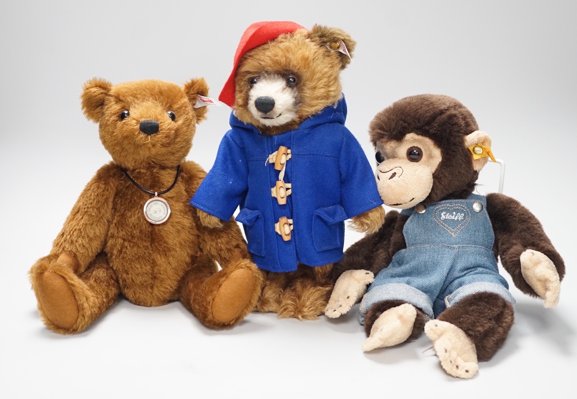 Three boxed Steiff toys: a Paddington bear, a brown bear and a monkey